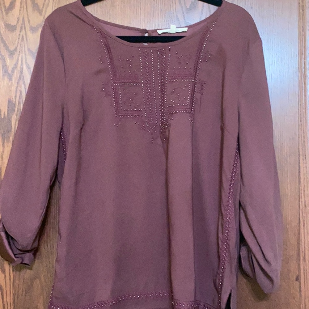 Will be donated 10/01. 
Like new blouse with detail on front, side hem & bottom.